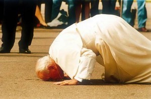 Pope John Paul kissing the ground